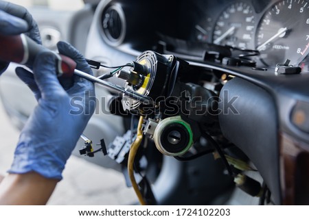 Close Up car steering wheel repair after the accident. Disconnecting of driver's airbag. With soft-focus.  Royalty-Free Stock Photo #1724102203