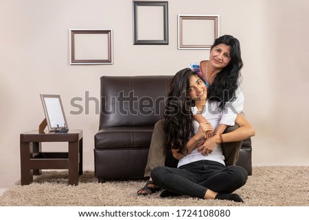 Mexican mother and daughter hugging on mother's day 