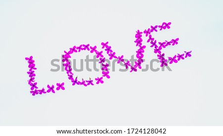 The word love from lilac flowers,top view,photo wallpaper,romantic inscription.