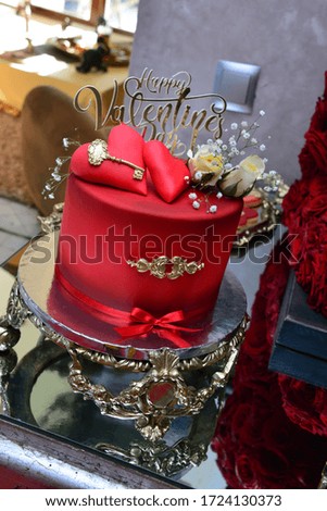 Red wedding cake with red hearts over it