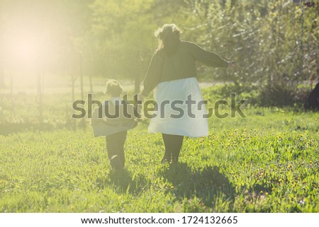 Mothers day greeting card template with mother and sun holding hands together or holding each other in beautiful sunny day
