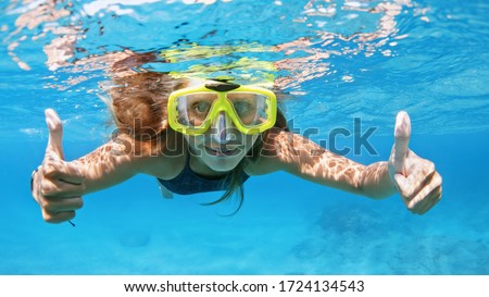 Happy family - active young woman in snorkeling mask dive underwater, see tropical fishes in coral reef sea pool. Travel adventure, swimming activity and watersports on summer beach cruise with kids.