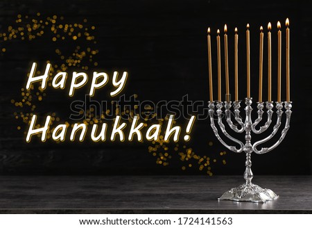 Silver menorah on black wooden table. Happy Hanukkah!