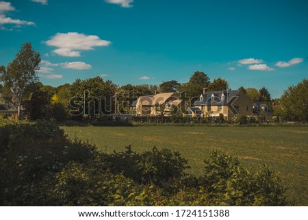 English country Meadow with village house 