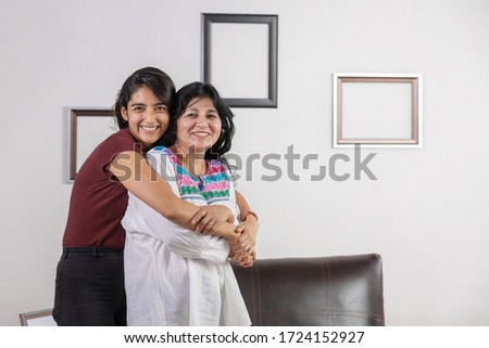 Mexican mother and daughter hugging on mother's day 