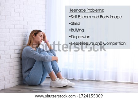 Sad girl sitting on floor and suffering from teenage problems  Royalty-Free Stock Photo #1724155309