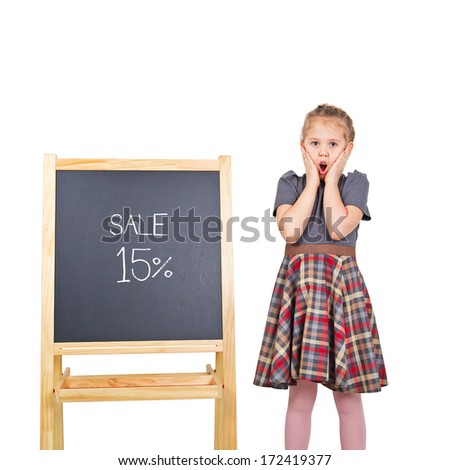 Marketing sale concept. Colorful studio portrait of beauty little girl with chalkboard isolated on white background. Chalkboard with sale text. (isolated with clipping path)