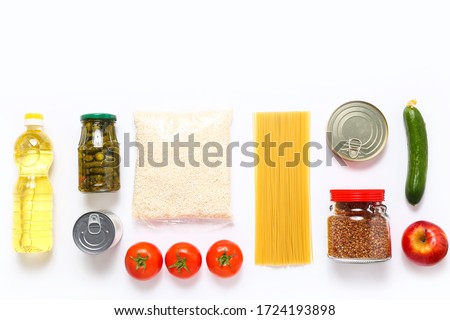 Food supplies for the period of quarantine on white background. Set of grocery items from canned food, vegetables, pasta, cereal. Food delivery concept. Donation concept. Top view. Royalty-Free Stock Photo #1724193898