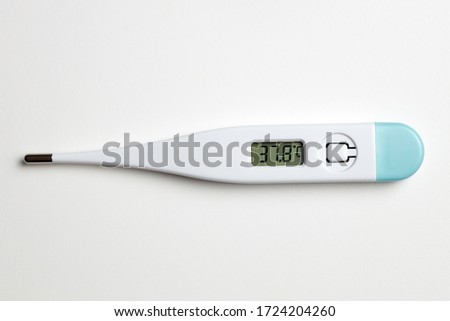 Digital thermometer on white background marking high temperature