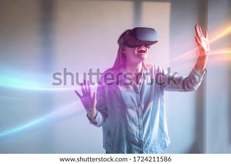 An Young Happy Smiling Woman is Using Innovative Futuristic Technology VR Glasses with Augmented Reality Holograms. 