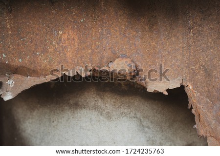 Texture of old rusty metal with torn edges and a hole