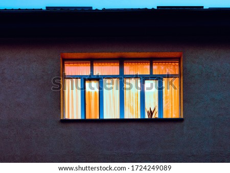 yellow orange soft warm light inside big window at upper level Royalty-Free Stock Photo #1724249089