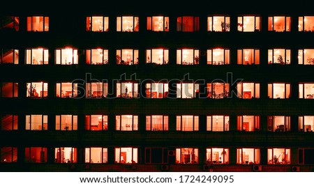 red lamps in many night windows as pattern Royalty-Free Stock Photo #1724249095