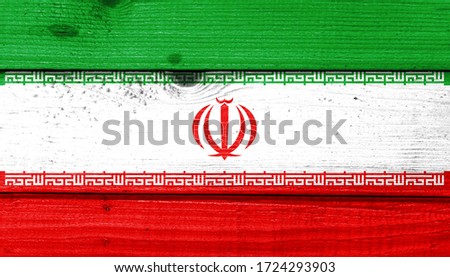 Iran flag painted on old wood plank background. Brushed natural light knotted wooden board texture. Wooden texture background flag of Iran