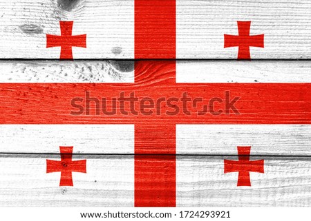 Georgia flag painted on old wood plank background. Brushed natural light knotted wooden board texture. Wooden texture background flag of Georgia