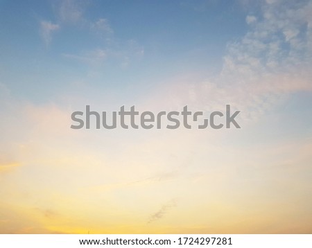 golden and blue sky with white clouds. 