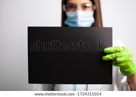 Doctor holding a blank sheet of paper with space for text