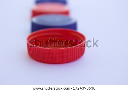 The first red plastic plug in a row focused
