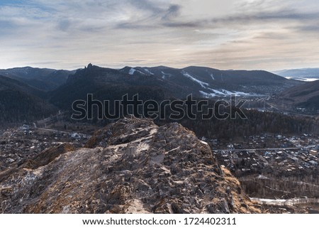 Mountain spring sunset landscape with beautiful clouds and pine forest. View from the cliff