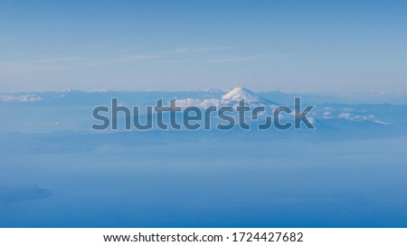 Fuji mountain from above in far distance with blue theme blue sky and cloud