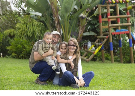 Loving Family, Father, Mother And Their Children Having Fun Outdoors