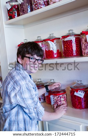 Teenager shopping at the boutique candy store.