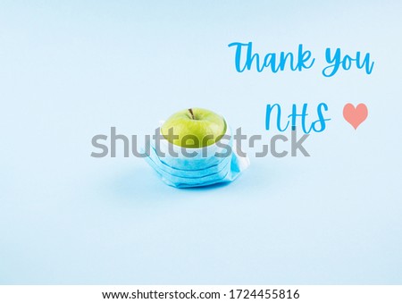 Thank you card for NHS staff, doctors and nurses who save lives every day. Apple with face mask