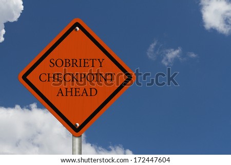 Stop Drinking and Driving, An American road warning sign with words Sobriety Checkpoint Ahead with blue sky