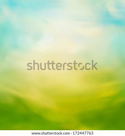 Spring or summer abstract nature background with meadow and blue sky in the back