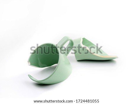 Broken coffee mug on white background, broken cup pieces, Broken relationship and Parting concept Royalty-Free Stock Photo #1724481055
