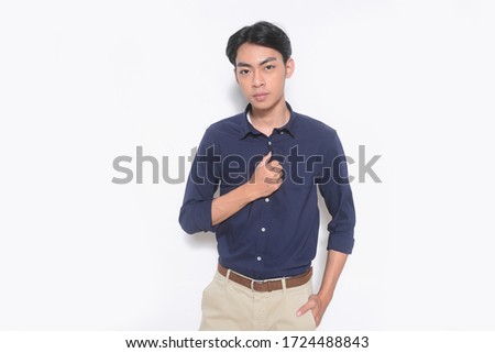 young man
 isolated on white background wearing fashion long sleeved shirtwith khaki pants posing in studio

