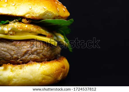 Hamburger on a black background, junk food
