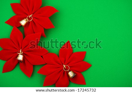 Three red poinsettias with bells on green background, poinsettia border