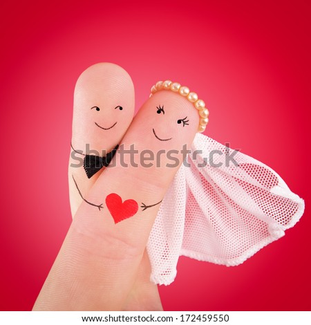 just married couple, newlyweds painted at fingers against red background, good use for wedding invitation card Royalty-Free Stock Photo #172459550