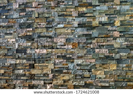 Decorative wall made of processed stones. Different types of decorative stone