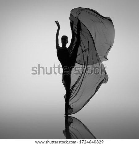 Ballerina dancing with black cloth