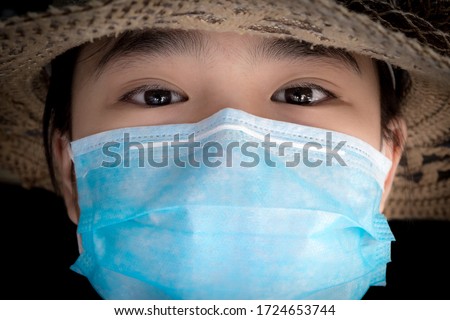 Close up photo of girl wearing facial mask protecting against pandemic.