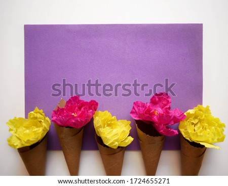 Flowers in a cone on a lavender and white background. Perfect layout for a thank you note or an invite.
