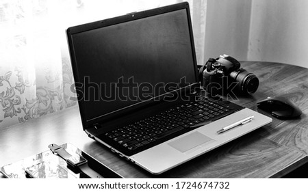 Working space of Photographer or Designer which including of dslr camera lens and wireless mouse on wood desk. Smart Phone, Smart Watch, computer and mouse, tablet for professionals photographer.