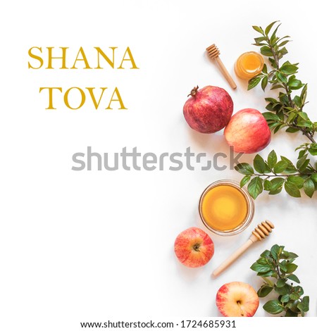 Rosh Hashanah jewish New Year holiday concept. Creative layout of traditional symbols - apples, honey, pomegranate isolated on white, top view, copy space. Royalty-Free Stock Photo #1724685931