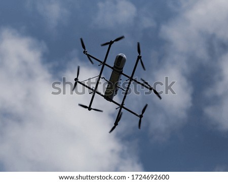 Oktokopter flies in the blue sky