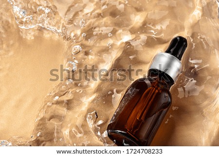 Cosmetic bottle with pipette in wavy water, top view