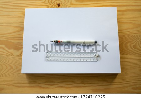 A4 Blank white paper stack, Plastic Ruler, Mechanical pencil or Clutch-type pencil on wooden background, Close up & Macro shot, Communication, Business, Education, Stationery concept