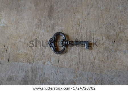 An Old Key on a Wooden Surface