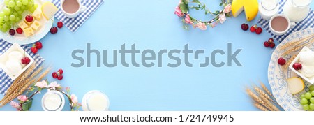 Top view photo of dairy products over pastel blue background. Symbols of jewish holiday - Shavuot Royalty-Free Stock Photo #1724749945