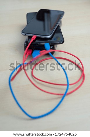 Powerbank charger for 2 phones, photographed from above on a table.