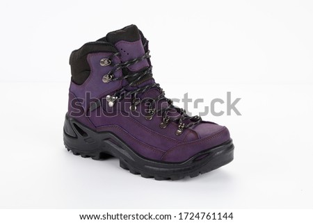 Purple hiking boots on white background .