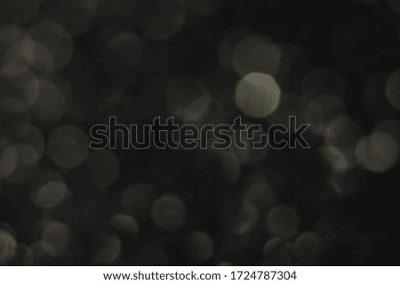 Silvery boke on a black background. brilliant vintage lights background. de-focused