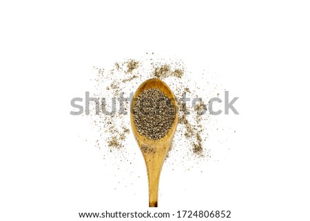close up black pepper in wooden spoon on white background isolated
