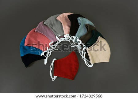 DIY fabric cotton face mask isolated on gray background. Top view of Colorful Handmade cotton cloth face mask protects against saliva, cough, dust and virus. Coronavirus preventive cotton mask.